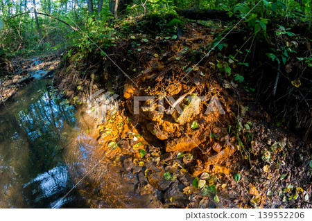 Ferruginous source painted bright orange, natural ocher in nature 139552206