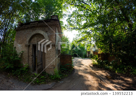Abandoned checkpoint with a brick security booth surrounded by green thickets Abandoned checkpoint with a brick security booth surrounded by green thickets 139552213