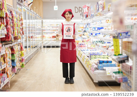 一名年輕女子在超市商品前舉著反竊盜標語。 一名年輕女子在超市商品前舉著反竊盜標語。 139552239