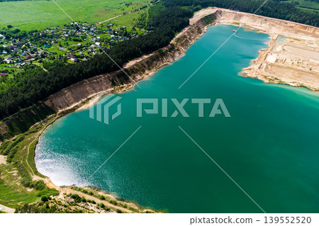 Aerial view of a flooded sand quarry in the countryside. Bolotsky quarry, Kaluga region Aerial view of a flooded sand quarry in the countryside. Bolotsky quarry, Kaluga region 139552520
