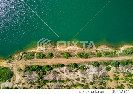 Aerial view of the coastline of a flooded sand quarry 139552545