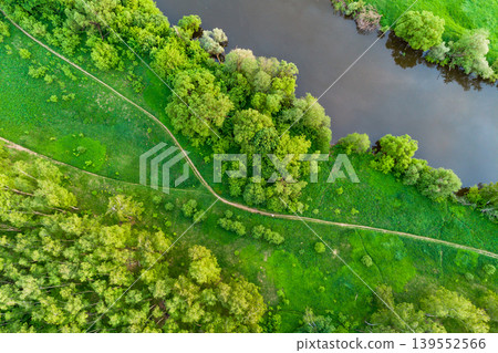 Aerial view of a green landscape with a path along the river Aerial view of a green landscape with a path along the river 139552566