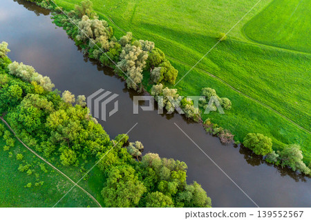 Aerial view of a river bed surrounded by green fields Aerial view of a river bed surrounded by green fields 139552567