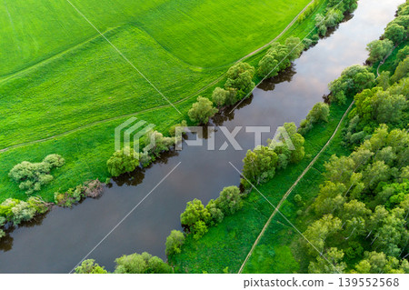 Flight over the river in the middle of a green summer landscape 139552568