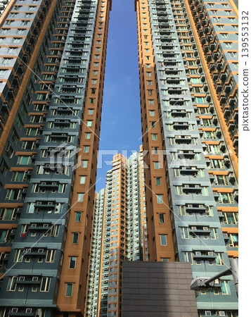 Hong Kong's densely packed high-rise residential areas and the vast blue sky create a stunning urban landscape. Hong Kong's densely packed high-rise residential areas and the vast blue sky create a stunning urban landscape. 139553132
