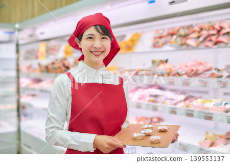 A young woman working at a supermarket's sample counter A young woman working at a supermarket's sample counter 139553137