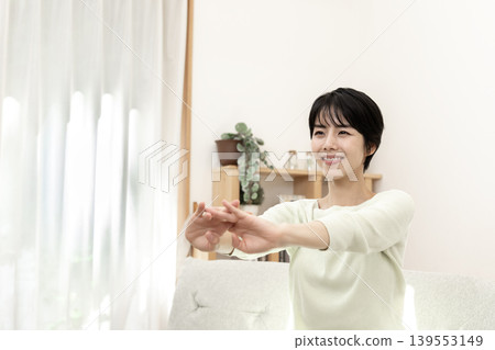 A woman stretching to refresh herself. A woman stretching to refresh herself. 139553149