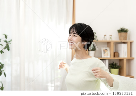 A woman stretching to refresh herself. A woman stretching to refresh herself. 139553151