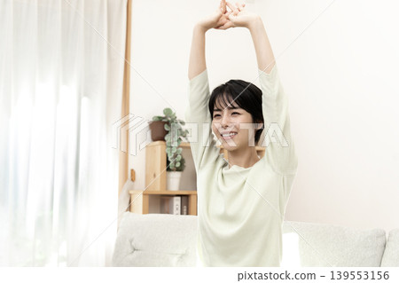 A woman stretching to refresh herself. A woman stretching to refresh herself. 139553156