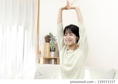 A woman stretching to refresh herself. A woman stretching to refresh herself. 139553157