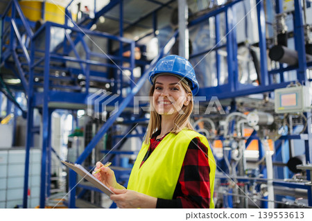 Woman worker woring in industrial factory, programming machine. Woman worker woring in industrial factory, programming machine. 139553613
