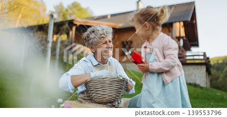 Girl helping older grandmother with gardening, planting flowers. Girl helping older grandmother with gardening, planting flowers. 139553796
