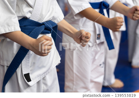 Close-up of young karate students in white gi Close-up of young karate students in white gi 139553819