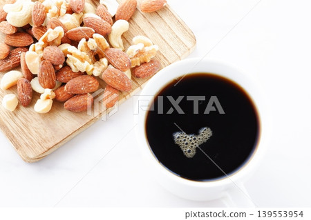 Mixed nuts (almonds, walnuts, cashews, macadamia nuts) and freshly brewed coffee Mixed nuts (almonds, walnuts, cashews, macadamia nuts) and freshly brewed coffee 139553954