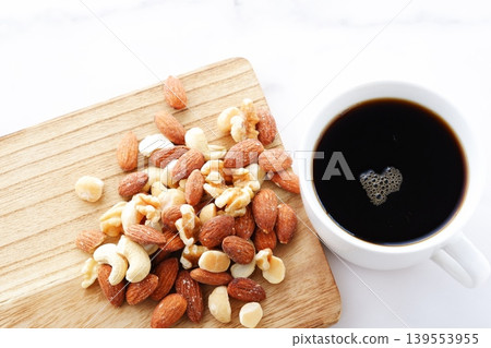 Mixed nuts (almonds, walnuts, cashews, macadamia nuts) and freshly brewed coffee Mixed nuts (almonds, walnuts, cashews, macadamia nuts) and freshly brewed coffee 139553955