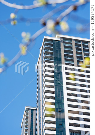 Modern high-rise residential buildings with beautiful new facades against a clear blue sky. 139554173