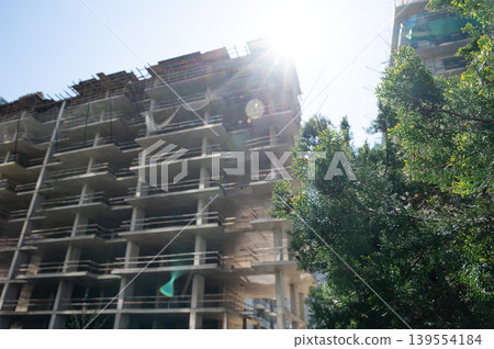 High-rise building under construction with tower crane, urban development and real estate concept 139554184