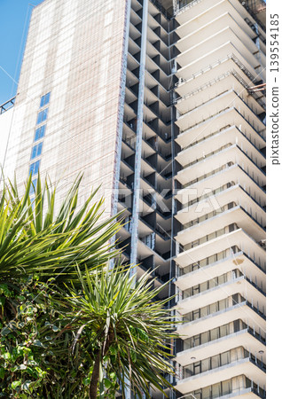 High-rise building under construction against a clear blue sky. 139554185