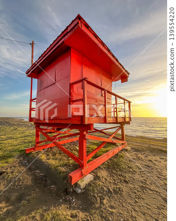 Red Lifeguard Tower on Beach at Sunset 139554220
