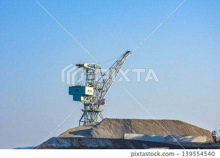 A giant jib crane stands out against the blue sky. A giant jib crane stands out against the blue sky. 139554540