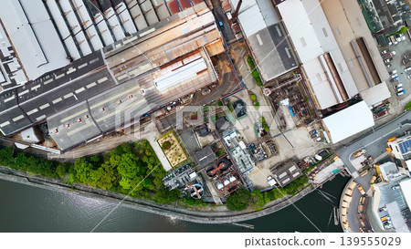 Aerial drone footage of a factory landscape from directly above. Aerial drone footage of a factory landscape from directly above. 139555029