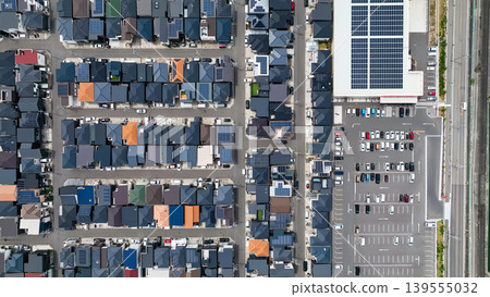Aerial drone footage of a residential area and roads from directly above. Aerial drone footage of a residential area and roads from directly above. 139555032