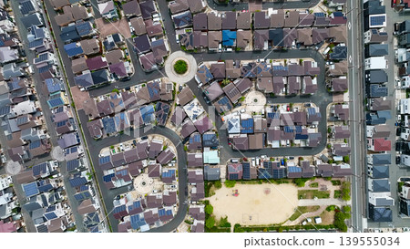 Aerial drone footage of a residential area and roads from directly above. Aerial drone footage of a residential area and roads from directly above. 139555034