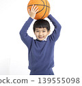 Happy boy holding basketball with his hands 139555098