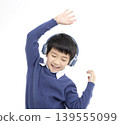Cheerful boy in headphones singing and dancing 139555099
