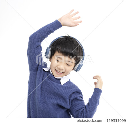 Cheerful boy in headphones singing and dancing 139555099