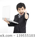 Happy  boy  gives thumbs up while using laptop 139555103