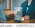 A professional making a secure online payment using a smartphone, highlighting digital security and modern technology. 139555111