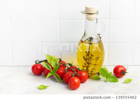 Olive oil bottle with fresh cherry tomatoes basil 139555402