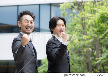 A portrait of a trustworthy sales team in suits in front of an outdoor building, showcasing corporate sales and corporate growth with a triumphant pose. A portrait of a trustworthy sales team in suits in front of an outdoor building, showcasing corporate sales and corporate growth with a triumphant pose. 139555525