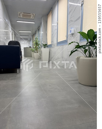 a modern, minimalist interior space, likely a reception area, lobby, or waiting room in a corporate or medical facility. 139555657