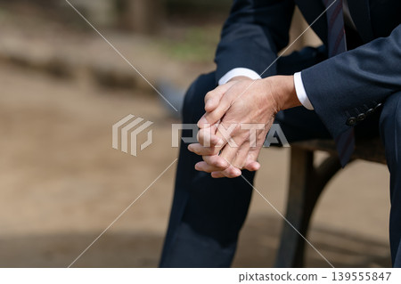 A depressed businessman's hands A depressed businessman's hands 139555847