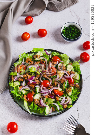 Fresh burger salad with ground beef and vegetables on a plate on the table vertical view Fresh burger salad with ground beef and vegetables on a plate on the table vertical view 139556025