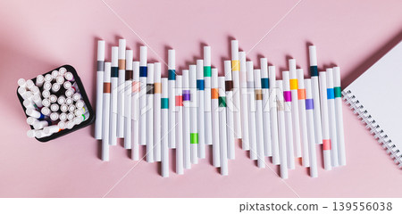 A set of acrylic markers for drawing and a sketchbook on a table top view web banner A set of acrylic markers for drawing and a sketchbook on a table top view web banner 139556038