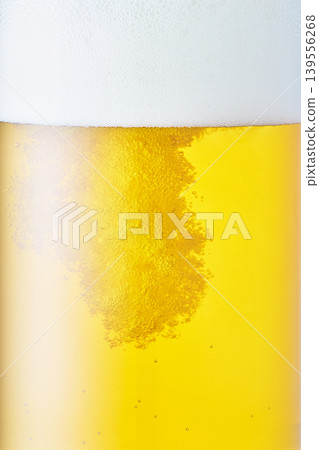 Draft beer poured into a glass, close-up Draft beer poured into a glass, close-up 139556268