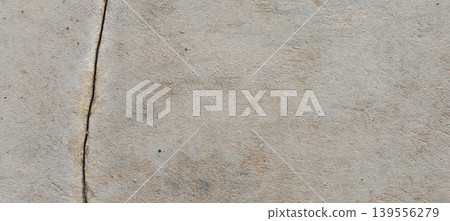 Grey concrete surface texture with aesthetic natural cracks. Grey concrete surface texture with aesthetic natural cracks. 139556279