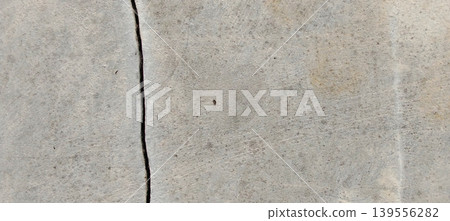 Grey concrete surface texture with aesthetic natural cracks. Grey concrete surface texture with aesthetic natural cracks. 139556282