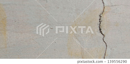 Grey concrete surface texture with aesthetic natural cracks. Grey concrete surface texture with aesthetic natural cracks. 139556290