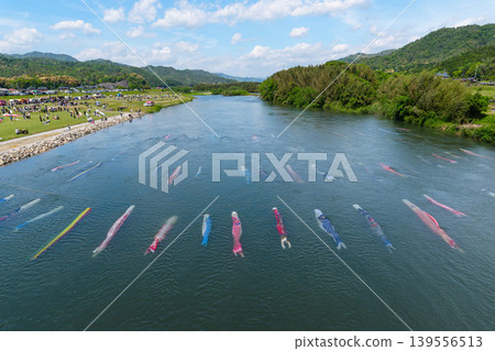 Saba River, Hofu City, Yamaguchi Prefecture: Carp streamers swimming in the water and the Saba River Koinagashi festival. Saba River, Hofu City, Yamaguchi Prefecture: Carp streamers swimming in the water and the Saba River Koinagashi festival. 139556513