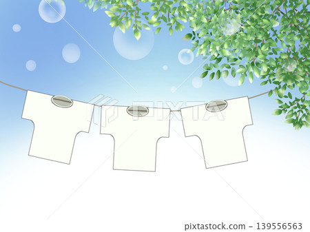A scene of T-shirts drying in the blue sky and lush green leaves. A scene of T-shirts drying in the blue sky and lush green leaves. 139556563