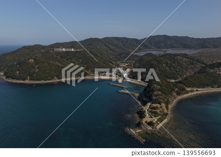 An aerial photograph showing the inlet and fishing village of Kada, Wakayama Prefecture, from a diagonal vantage point. An aerial photograph showing the inlet and fishing village of Kada, Wakayama Prefecture, from a diagonal vantage point. 139556693