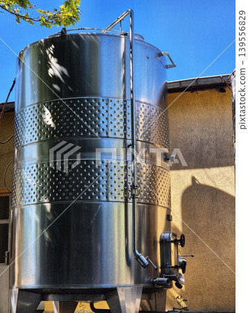 large stainless steel tanks for beverage production. metal tank for aging wine. 139556829