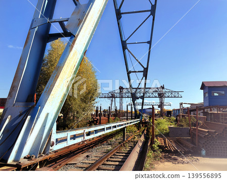 Gantry crane. The crane rides on rails. Blue sky photo Gantry crane. The crane rides on rails. Blue sky photo 139556895