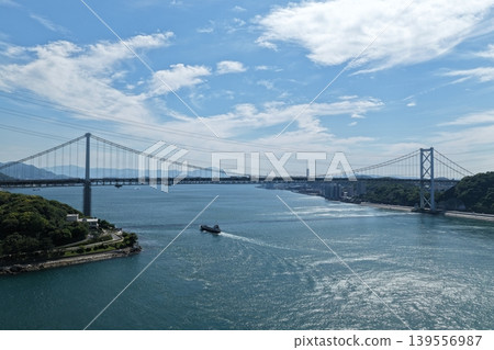 An aerial photograph showing the Kanmon Bridge and the Kanmon Strait from a diagonal vantage point. An aerial photograph showing the Kanmon Bridge and the Kanmon Strait from a diagonal vantage point. 139556987