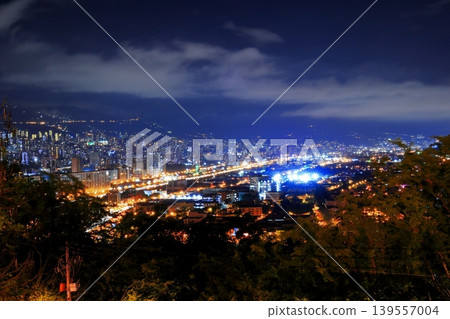 Panoramic night view of Medellín, Colombia, South America, with city lights shining against the Andes Mountains. Panoramic night view of Medellín, Colombia, South America, with city lights shining against the Andes Mountains. 139557004
