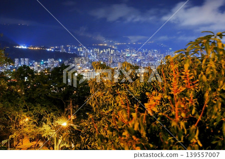Night view of Medellín, Colombia: A carpet of lights spread across the mountain slopes and the city's nightscape. 139557007
